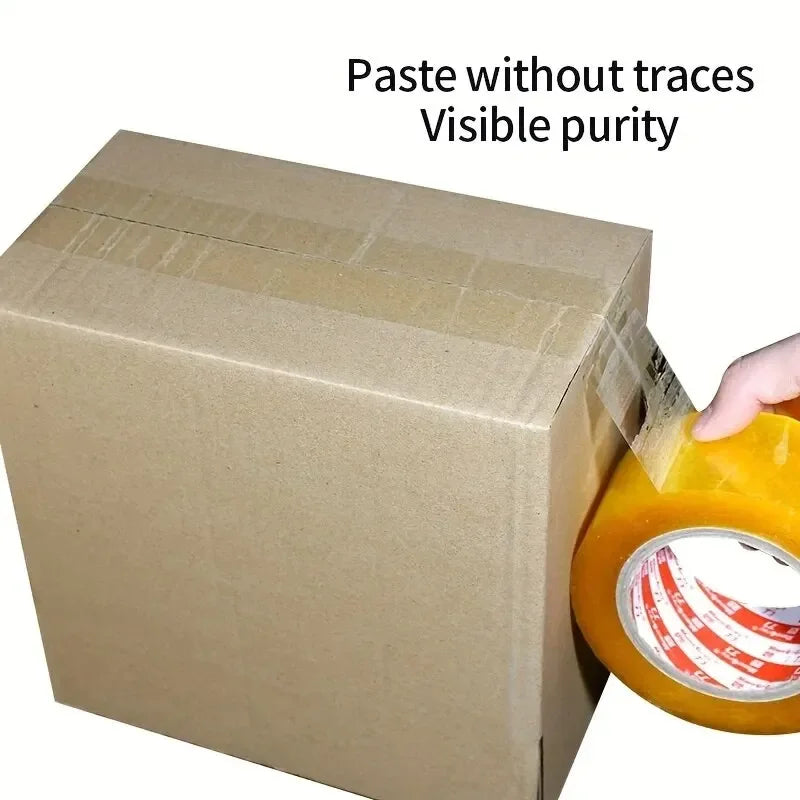 A hand is applying heavy-duty transparent packing tape to seal a cardboard box.