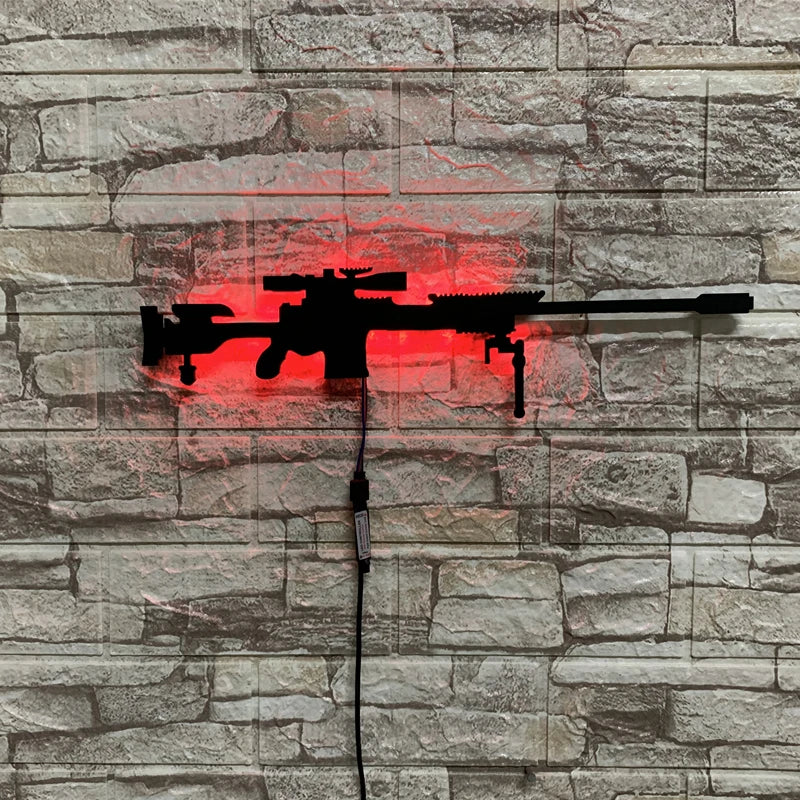 A red LED gun-shaped wall decor light is mounted on a gray stone wall.
