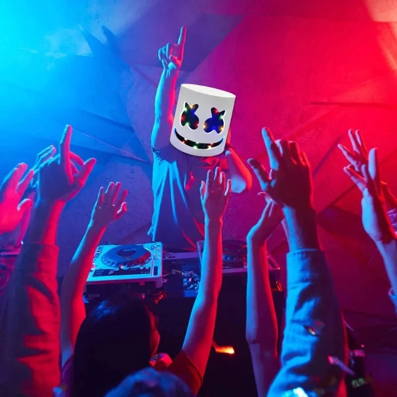 A group of people raise their hands in excitement around a white LED party mask with flashing lights.