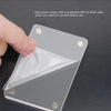 A hand is removing a protective film from a clear acrylic car sun visor photo clip piece.