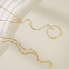 Gold ultra-thin layering chain bracelets with small clear stones displayed on a light background.