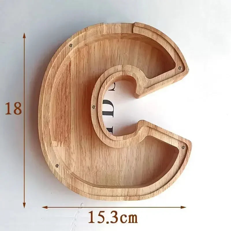 A wooden alphabet letter C shaped piggy bank coin box for kids with measurements shown.