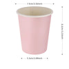 A pink scalloped paper cup with a white rim and a clear plastic lid.