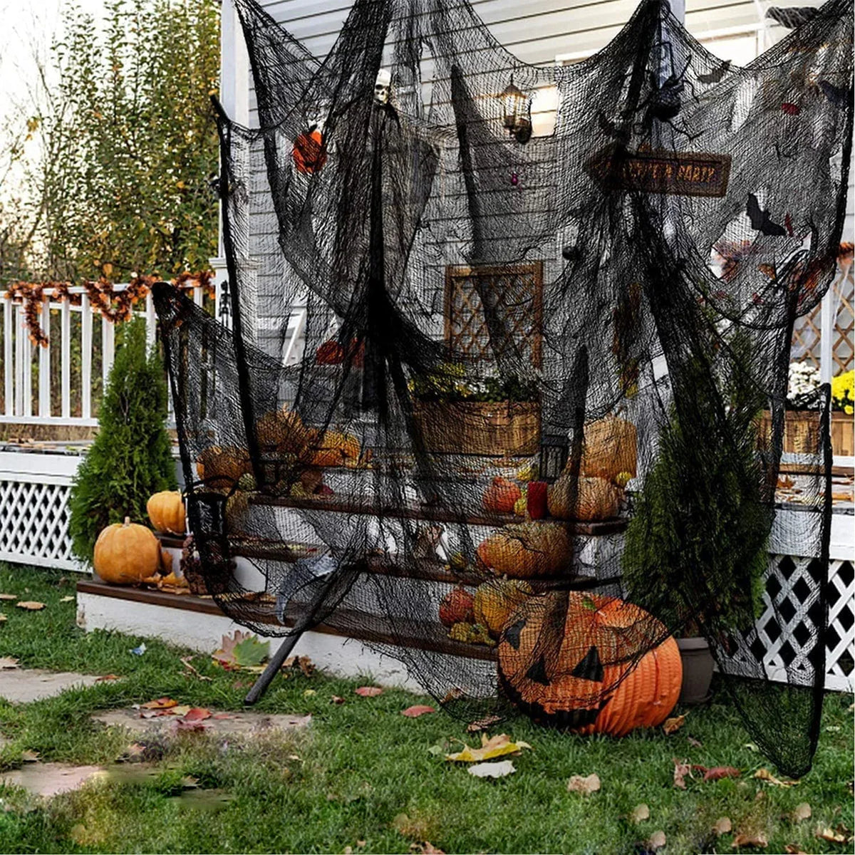 Black creepy gauze cloth draped over a wooden fence for Halloween decor