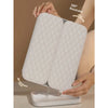 A person holds a white tri-fold LED makeup mirror with dimmable lighting, demonstrating its rotatable feature.