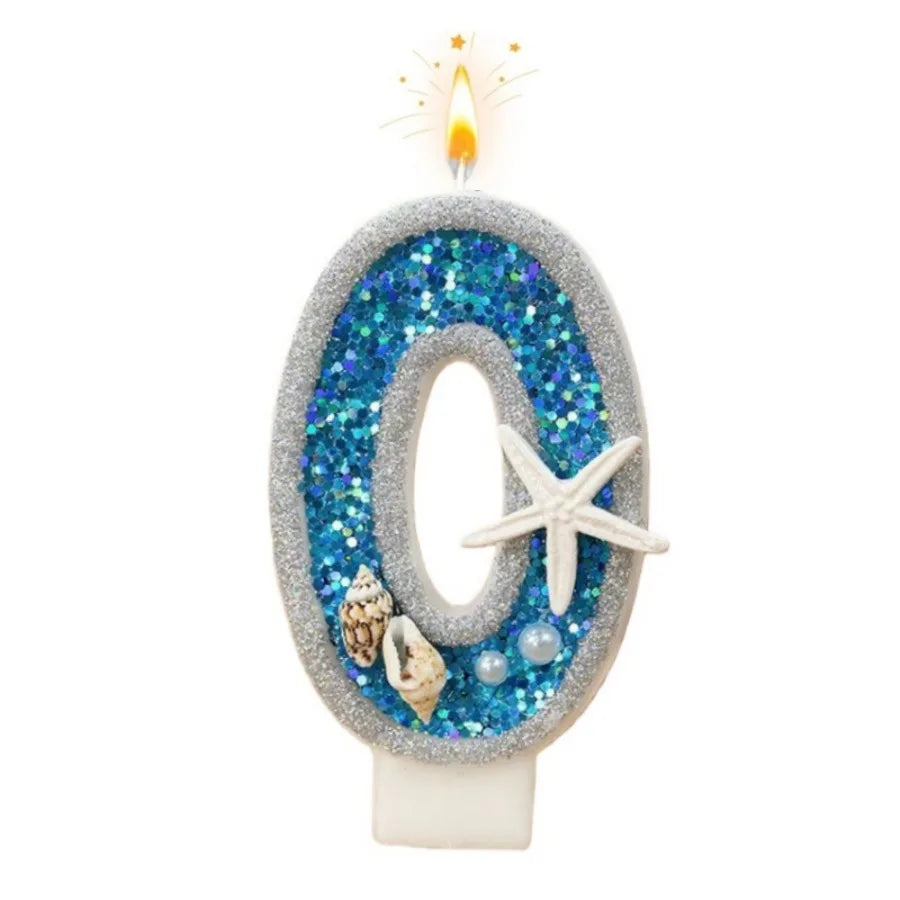 A glittery blue and silver number zero candle with a flame on top
