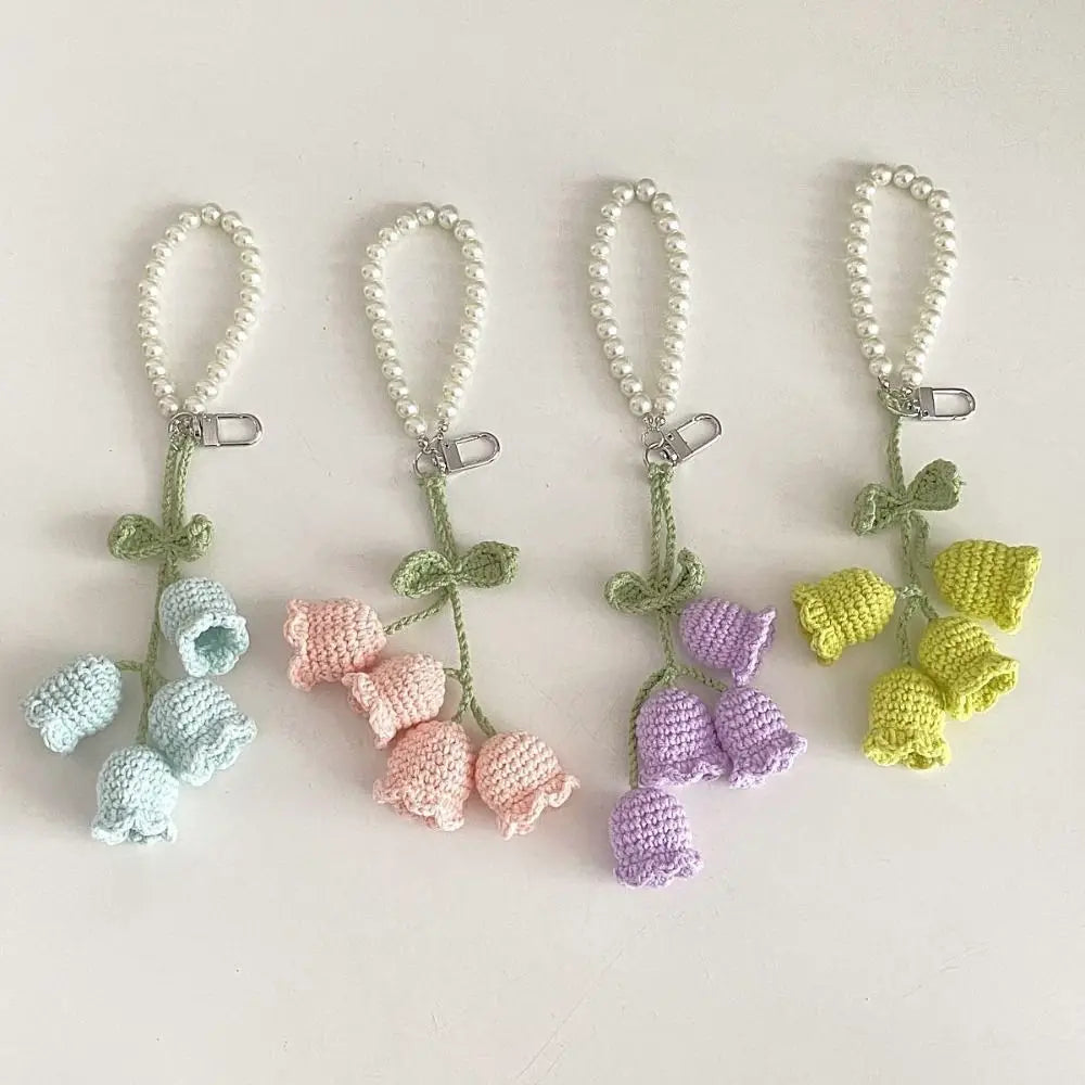 Four handmade pearl chain orchid key rings in pastel colors including light blue, pink, purple, and yellow.