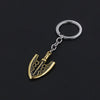 A gold-toned arrow metal keychain featuring a stylized blade design attached to a silver split ring.