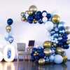 A large balloon garland arch featuring navy blue, gold, and light blue balloons against a white wall.