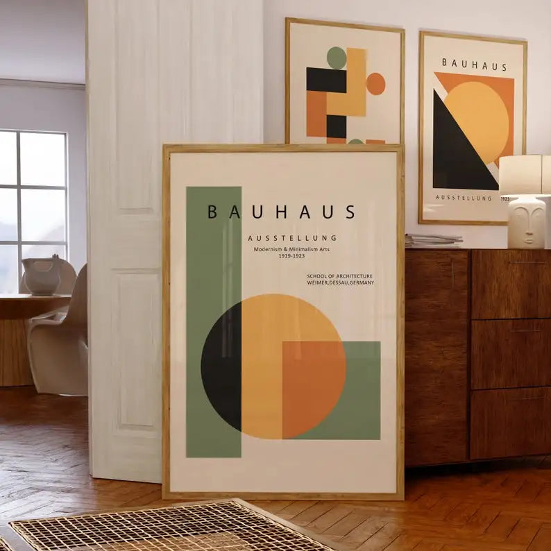 A framed Bauhaus style geometric art print featuring abstract shapes in orange, black, and olive green tones.