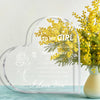 A clear heart-shaped acrylic keepsake gift with text 'To My Girl' and 'I Love You' surrounded by yellow flowers.