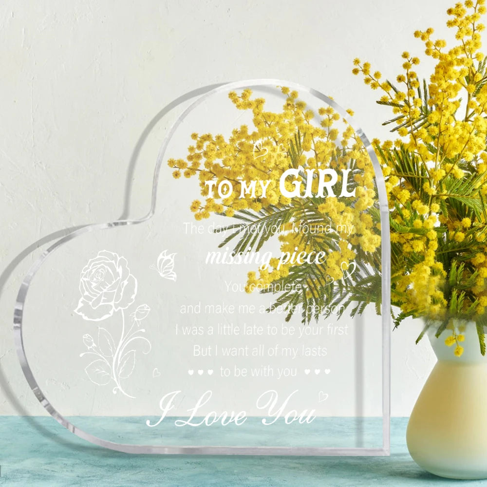 A clear heart-shaped acrylic keepsake gift with text 'To My Girl' and 'I Love You' surrounded by yellow flowers.