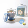 A blue and gold soy wax aromatherapy candle gift set in a tin box with a decorative lid.