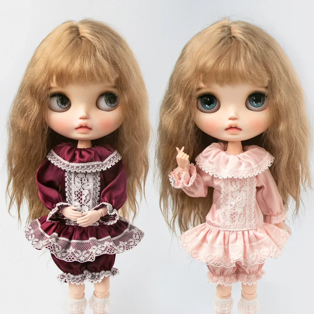 A pair of vintage lace pajama sets for 1/6 dolls, featuring light brown hair and pink and maroon fabric.