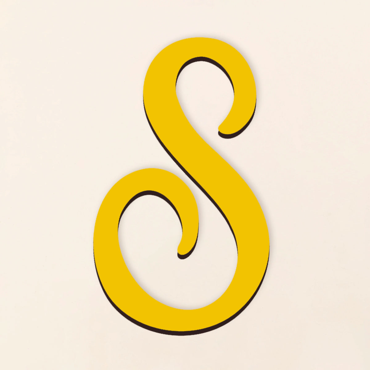 A yellow, cursive letter S cut from acrylic with a black outline.