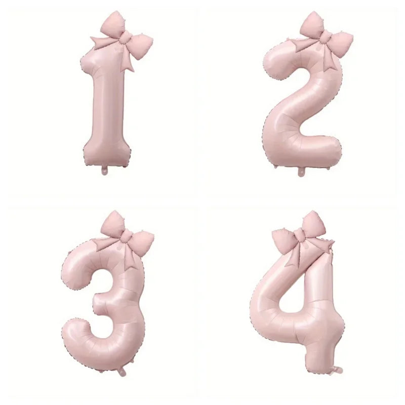 Four large pink foil number balloons shaped like 1, 2, 3, and 4 with bows