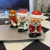 Three clockwork wind-up figurines depicting a reindeer, a snowman, and Santa Claus for festive decor