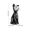 A black and white resin figurine set of a dog and cat with colorful markings.