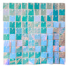 A grid of iridescent square panels in shades of teal, blue, and pink glitter for a wall backdrop.