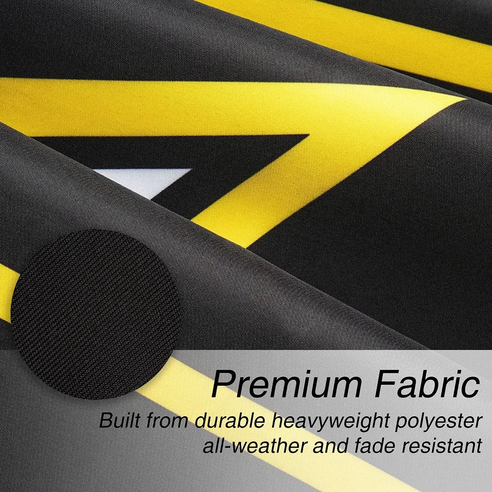 Close-up of a black and yellow striped fabric banner showing a diagonal design with a microphone on the left.