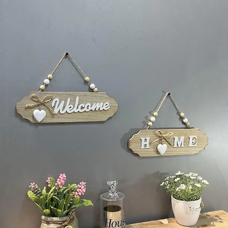 Rustic wooden door welcome sign with the words Welcome and Home mounted on a gray wall.