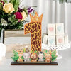 A wooden party ornament shaped like the number one with a crown and jungle animals.