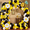 A colorful balloon arch set featuring yellow, black, and white balloons shaped like bees and daisies.