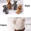Three handmade stuffed bears in various shades of brown and gray displayed next to a sign labeled Beautiful