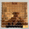A grid of square, iridescent gold and bronze sequin shimmer wall panels used as a sparkling backdrop.