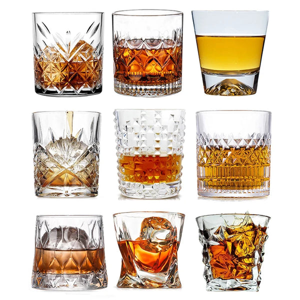 A collection of various whiskey glasses, including rocks glasses and tumblers, showcasing different styles and amber liquid.