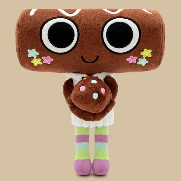 A brown plush toy resembling a face with large black eyes and small star embellishments, standing on striped legs.