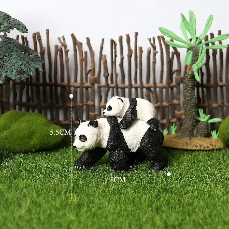 A realistic panda figurine set featuring a panda and a small palm tree in a natural green landscape.