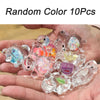 A hand holds a collection of 10 glow-in-the-dark mini sea turtle figurines in various colors for crafts and decor.