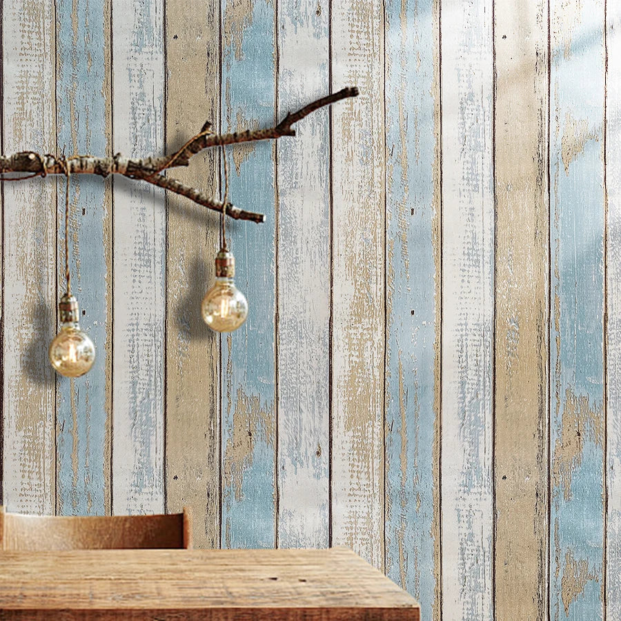 Rustic faux wood peel-and-stick wallpaper featuring vintage blue and white plank design on a wall.