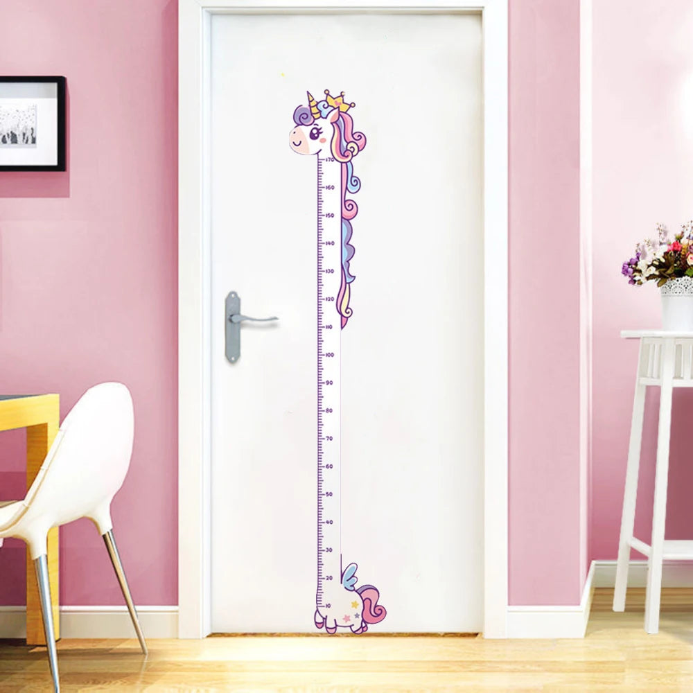 A white door features a unicorn-themed height chart sticker on the surface.