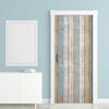 Rustic faux wood peel-and-stick wallpaper featuring vintage blue and white plank design on a door.