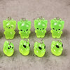 A set of six glow-in-the-dark cartoon kitty duck resin charms in various shades of lime green.