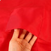 A hand is touching a bright red waterproof kitchen apron with a front pocket.