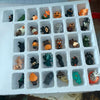 A white advent calendar box filled with 31 small Halloween-themed figurines.