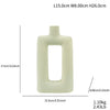 A light beige ceramic vase with a rectangular opening and rounded edges.