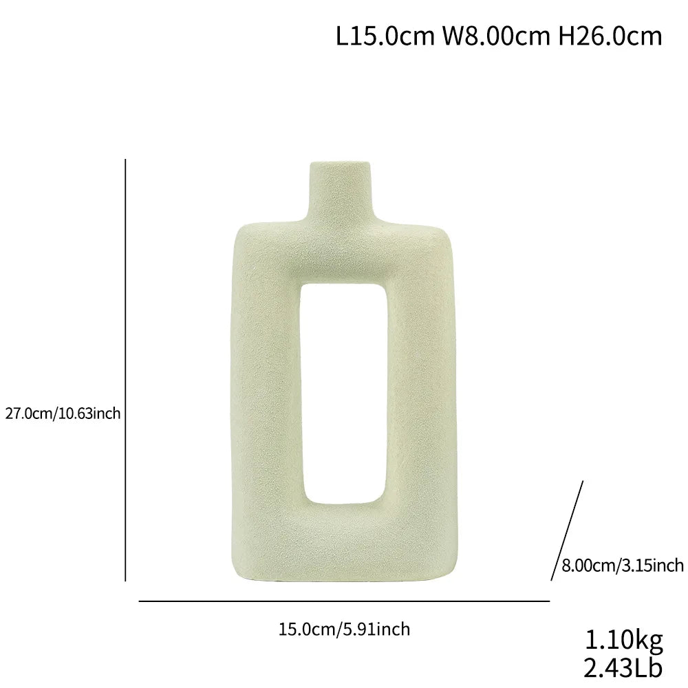 A light beige ceramic vase with a rectangular opening and rounded edges.