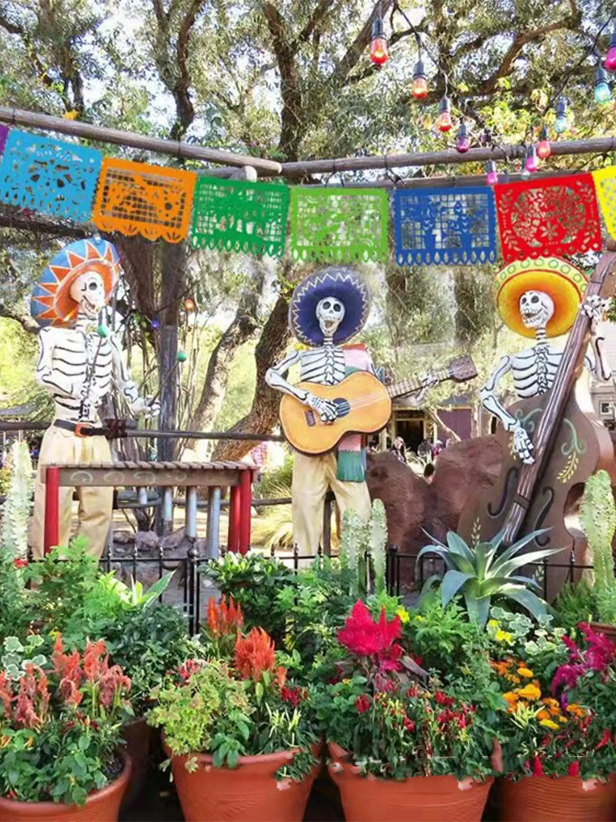 Decorative felt flags hanging outdoors with skeletons and guitars as party decorations