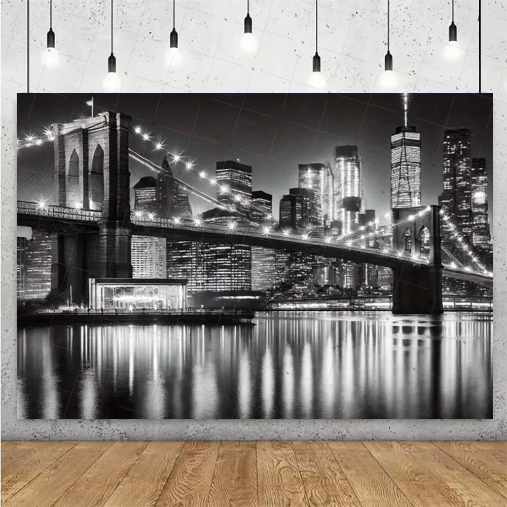 Black and white photograph of a night city skyline with illuminated high-rise buildings reflected in water.