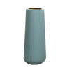 A tall, cylindrical vase with vertical ribbed texture in a muted blue-green color.