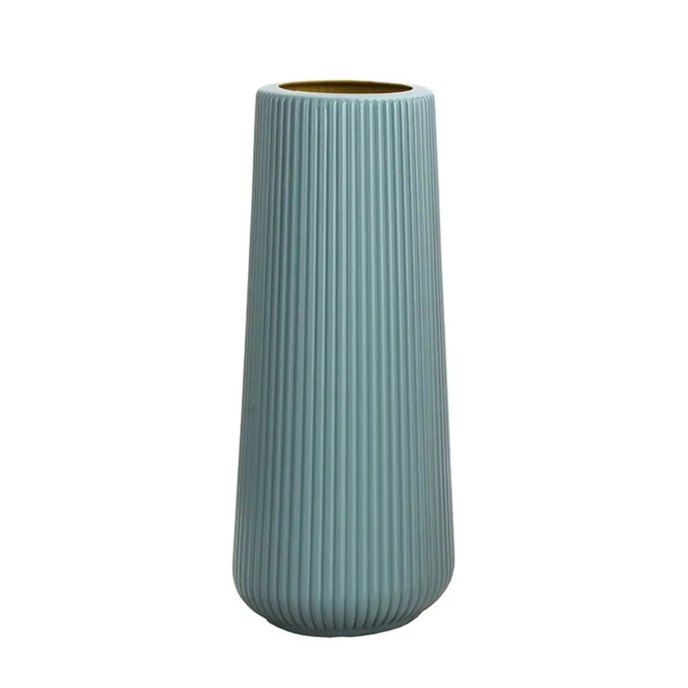 A tall, cylindrical vase with vertical ribbed texture in a muted blue-green color.