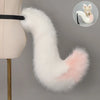 A white faux fur fox tail and ear costume set attached to a stand.