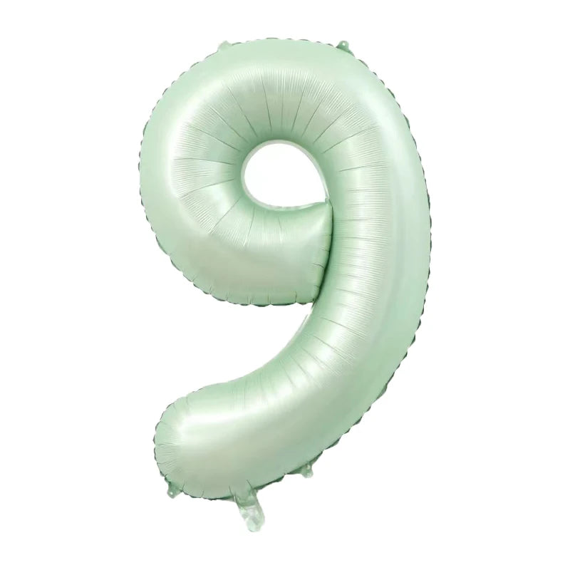 A light mint green foil number balloon shaped like the number 9.