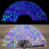 A close-up of a UV fluorescent folding fan with iridescent purple and green swirling patterns.