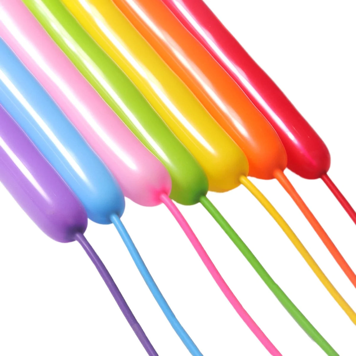 A close-up of a bundle of colorful latex strip balloons in various shades including pink, yellow, orange, and green.