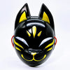 A glossy black fox face mask with yellow accents, shown from the front.